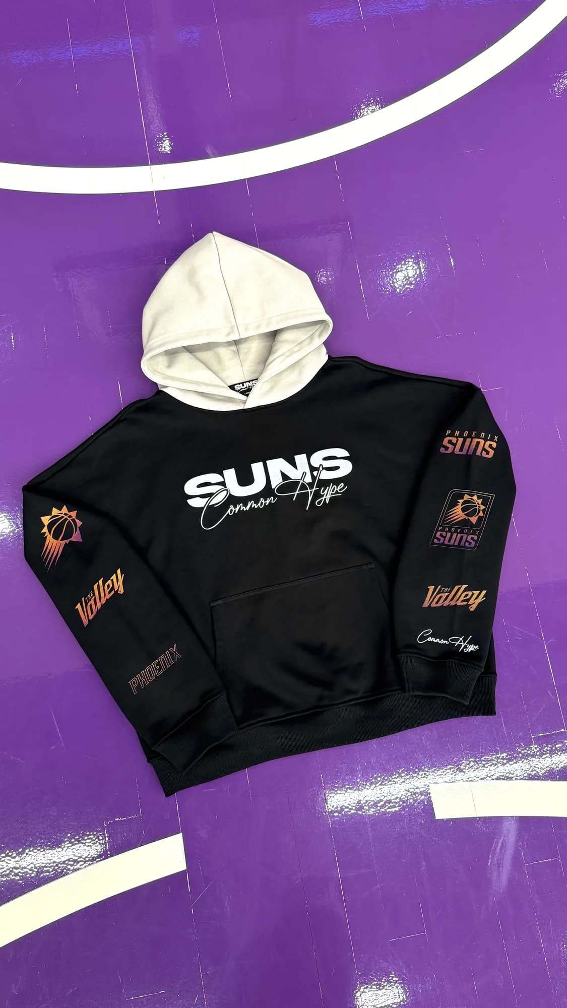 Black Common Hype Phoenix Suns hoodie with a cream hood and embroidered sleeve graphics