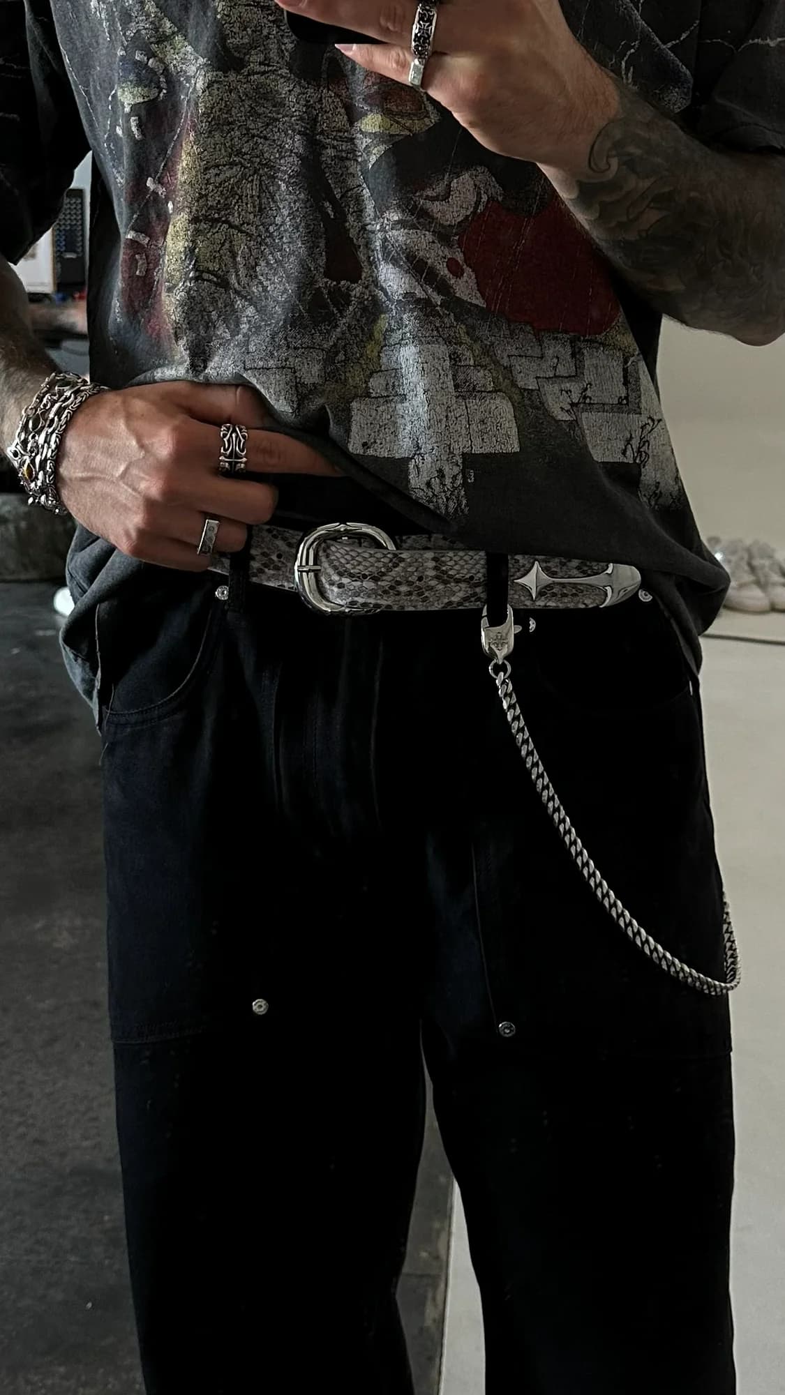 Commons Studios embellished belt with a silver buckle styled with black trousers