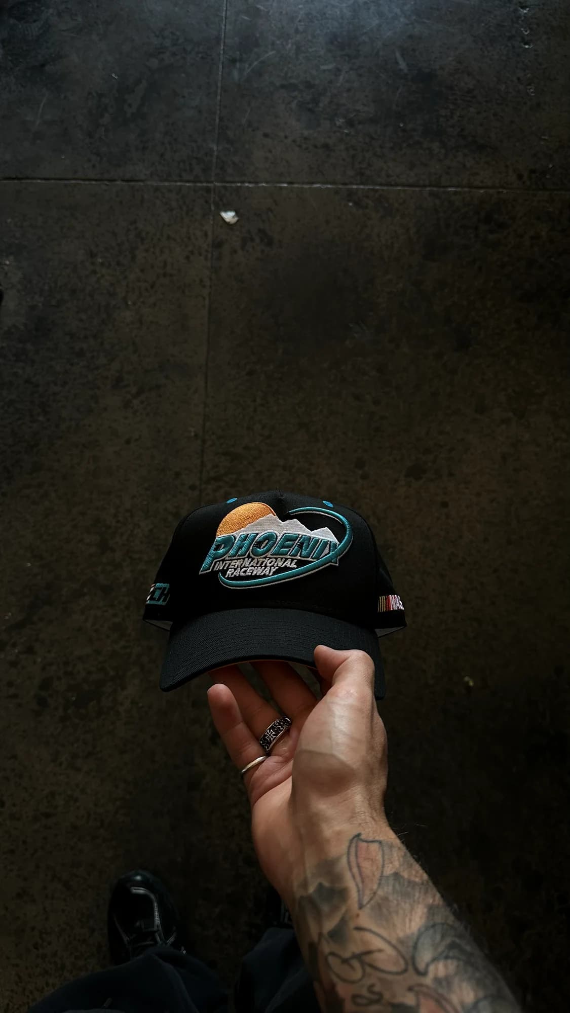 Black Common Hype NASCAR cap with embroidered Phoenix artwork