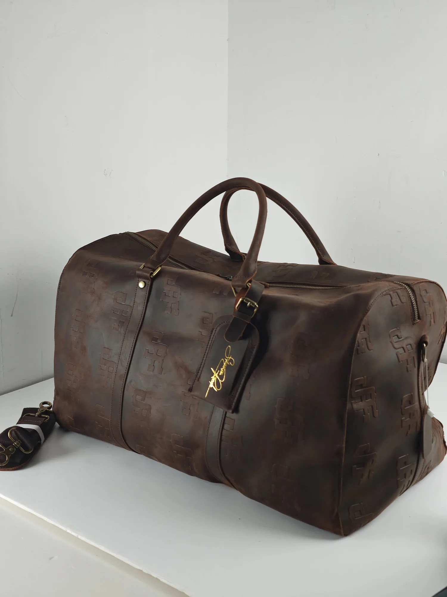 Brown Stevenson Ranch leather weekender bag with handles and metal hardware