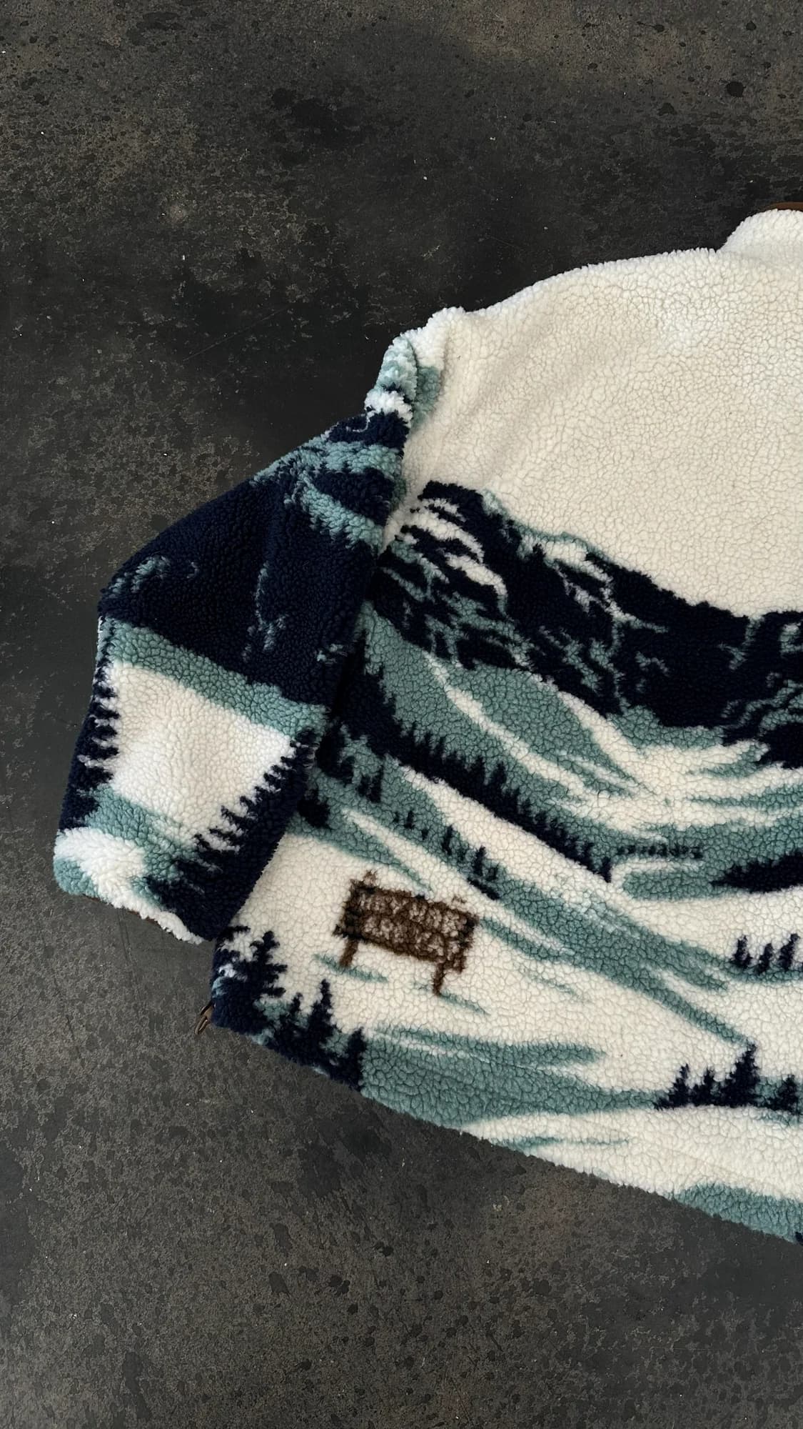 Close-up of the mountain pattern and ranch sign on Stevenson Ranch fleece