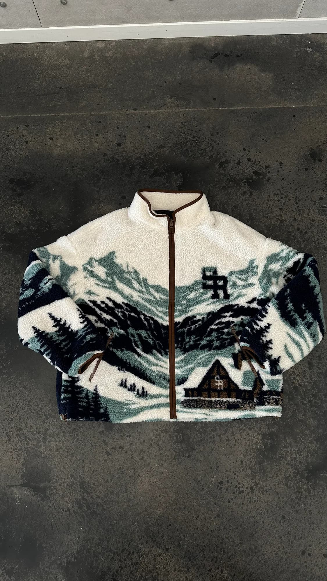 Stevenson Ranch zip fleece with a snowy mountain and cabin design