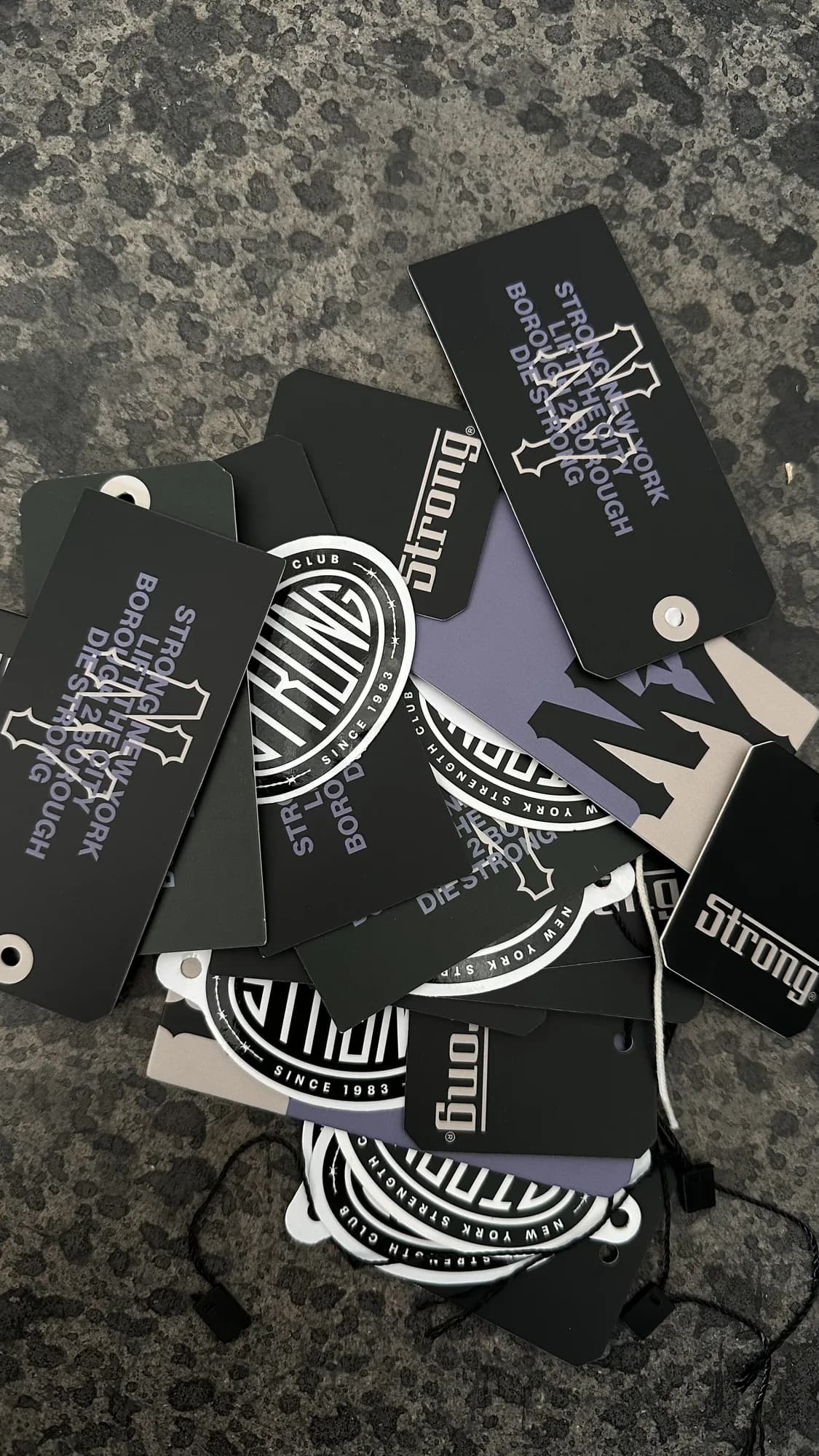 Assorted black and white Strong New York hang tags and branded labels